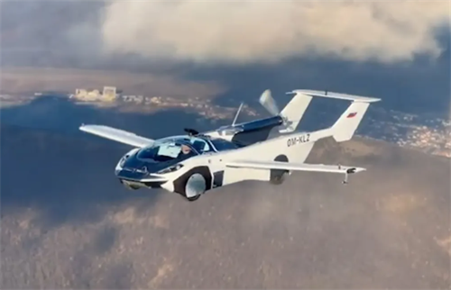 A flying car in flight over a landscape, showcasing the performance potential enabled by high-energy-density solid-state batteries.