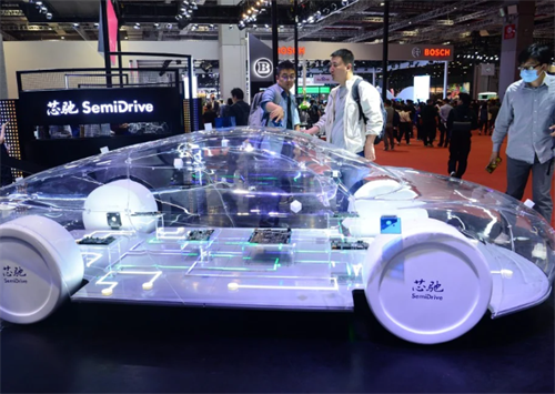 A transparent concept car at an auto show showcasing SemiDrive's cockpit-driving fusion chip technology
