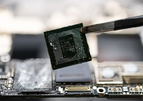 A Hisilicon automotive chip being handled with tweezers, representing the core hardware powering autonomous driving systems.